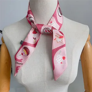 Detailed view of pink silk twilly scarf with ice cream and Pegasus cartoon patterns