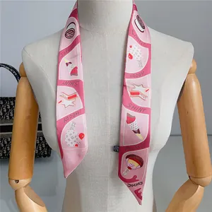 Detail of pink silk twilly scarf with ice cream patterns draped on a white mannequin