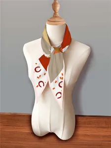 Detailed view of french style silk scarf with horseshoe print and geometric patterns