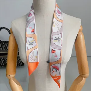 Detail of colorful twilly silk scarf with geometric patterns on a mannequin arm