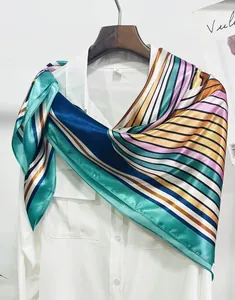 Detail of multi-color striped silk scarf with satin finish on a white shirt