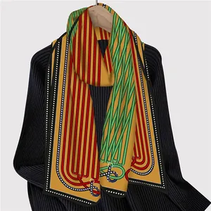 Detail of French silk scarf with geometric stripe chain pattern and buckle design