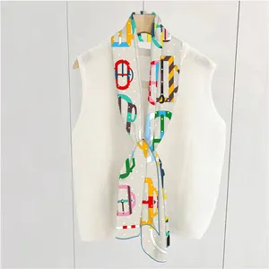 Detail of French style silk scarf with polka dots and belt print on white vest