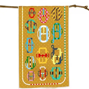 Ginger yellow scarf with pop-art buckle patterns hanging on a natural wooden branch