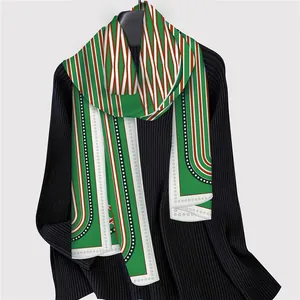 French geometric striped chain silk scarf styled on a black turtleneck sweater