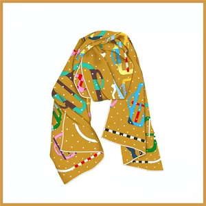 Detail of French style mustard silk scarf featuring colorful geometric patterns and rolled edges