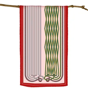 Detail of pink geometric scarf with red polka dot edges hanging on a natural branch