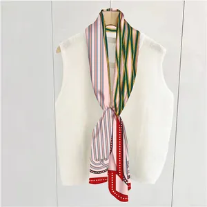 Detail of hand-rolled edges on a French geometric striped satin silk scarf for women