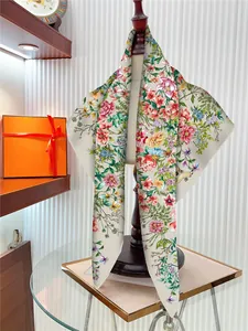 Detail of silk scarf with floral rose pattern draped on a mannequin in a luxury setting