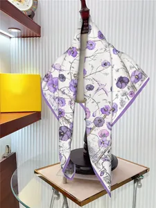 Close-up of elegant purple floral silk scarf on mannequin with realistic violet flower pattern