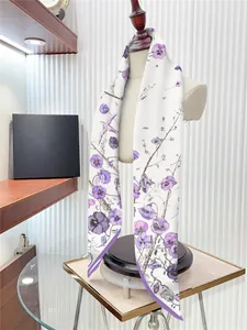 Detailed view of violet floral twill scarf draped on a mannequin in a boutique