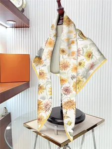 Detailed close-up of a premium silk scarf with elegant yellow sunflower floral patterns