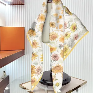 90cm silk-like scarf featuring sunflower prints and yellow rolled edges on a white base