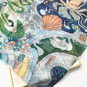 Detail of Georgette silk scarf showing vibrant underwater park illustration and fabric texture