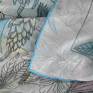 Macro shot of semi-transparent floral georgette scarf with fine blue hem edges