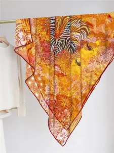 Detail of premium georgette scarf featuring jungle prints and zebra patterns on gold rack