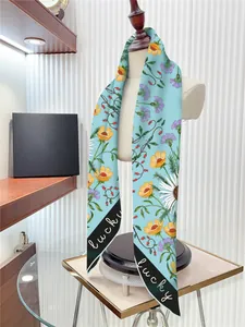 Detail of premium floral silk scarf with lucky lettering on black contrast edge