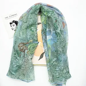Detail of Georgette scarf showing artistic green forest plant and snake print patterns