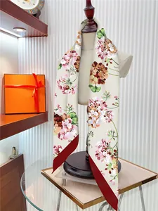 Detail of floral twilly silk scarf with pointed ends shown on a mannequin neck