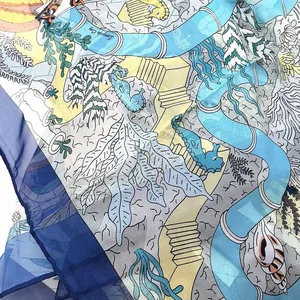 Detailed macro view of georgette scarf fabric showing marine pattern and rolled hem