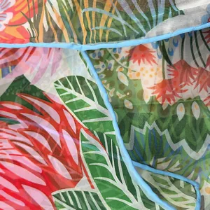 Close-up of translucent georgette scarf with tropical jungle and floral prints