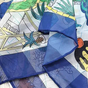 Detailed macro view showing the semi-transparent texture of the tropical print scarf