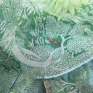 Macro view of georgette silk scarf with hand-painted forest plants and animal patterns