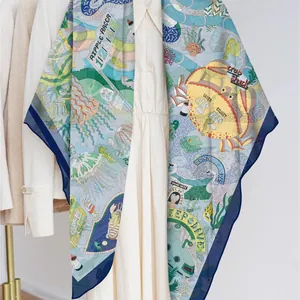 French georgette shawl with marine playground print layered over a cream dress