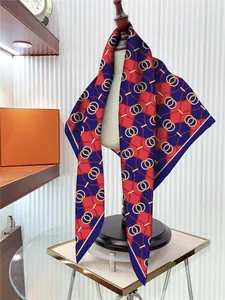 Detailed view of silk-like chain and buckle pattern square scarf on mannequin