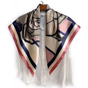 Detail of satin square scarf with floral print and geometric stripes on white shirt