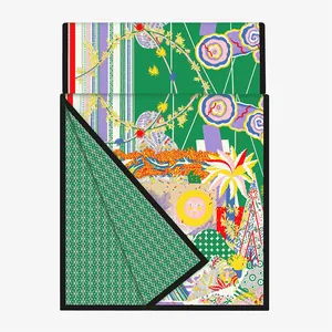 Close-up of a green double-layered long scarf with sun and floral tropical art patterns