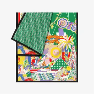 Detail of artistic silk scarf with sun, flora, and geometric star patterns on white base
