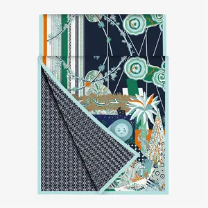 Close-up of silk scarf with artistic moon illustration and monogram texture pattern