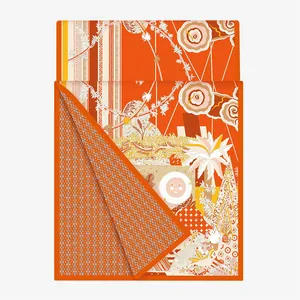 Close-up of orange silk scarf with tiger jungle prints and geometric H-pattern