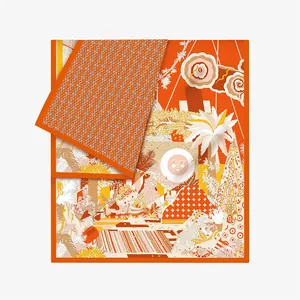 Detail of premium orange silk scarf featuring tropical flora and geometric patterns