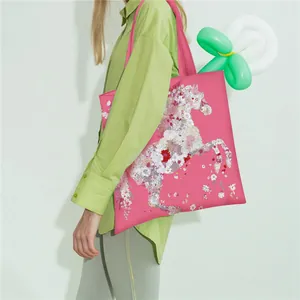 Close-up of fuchsia satin tote bag featuring a floral horse pattern and sturdy strap