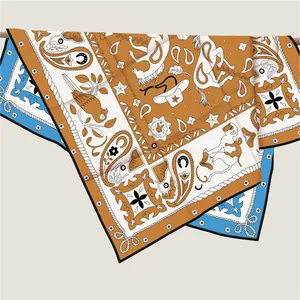 Detail of premium silk twill scarf showing animal prints and hand-rolled edges