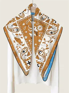 Detail of hand-rolled silk scarf featuring paisley motifs and tropical bird patterns