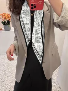 Classic nautical pattern silk scarf styled with a beige blazer for a chic look