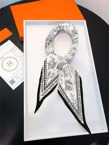 Detailed shot of nautical theme silk scarf with sailboat pattern in premium packaging