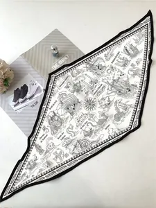 Detail of nautical silk scarf with mermaid and sailboat prints next to a magazine