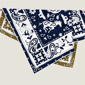 Detail of twill silk scarf featuring western cowboy illustrations and hand-rolled edges