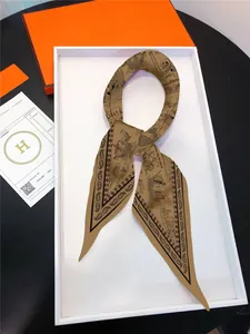 Detail of nautical sailboat pattern on silk twill scarf with premium orange gift box