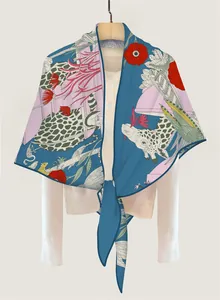 Detail of vibrant floral giraffe print silk scarf showing smooth satin texture and drape