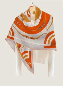 Detail of artistic geometric arrow pattern on a premium orange cashmere blend shawl