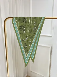 Detail of dark green silk scarf featuring vintage French nautical maps and paisley borders