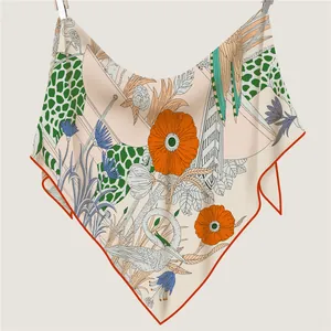 French silk scarf with giraffe leopard prints and orange hand-rolled edges hanging display