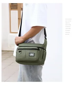 Detail view of military green waterproof oxford cloth messenger bag with adjustable strap