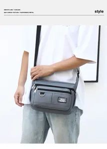 Waterproof grey oxford crossbody bag showing multiple zippered pockets and textured fabric