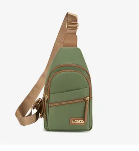 Close-up of green nylon chest bag with brown leather trim and golden metal logo
